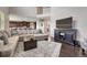 Open-concept living area with hardwood floors, large sectional sofa, and view into the kitchen at 27625 E Moraine Dr, Aurora, CO 80016
