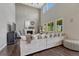 Bright living room featuring high ceilings, fireplace, hardwood floors, and a large comfortable sofa at 27625 E Moraine Dr, Aurora, CO 80016