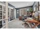 Cozy home office featuring a built-in bookshelf, natural light, and a comfortable workspace at 27625 E Moraine Dr, Aurora, CO 80016