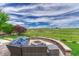 Inviting backyard patio with a built-in fire pit and comfortable seating at 27625 E Moraine Dr, Aurora, CO 80016