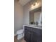 A half-bath showcasing modern fixtures, dark wood cabinetry, and a sleek, space-efficient design at 10177 E 62Nd Ave, Denver, CO 80238