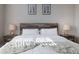 A cozy bedroom setting exhibits a modern wood headboard and matching nightstands with elegant lamps at 10177 E 62Nd Ave, Denver, CO 80238