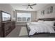 A comfortably appointed bedroom features a stylish wood-trimmed bed, ceiling fan, and plenty of natural light at 10177 E 62Nd Ave, Denver, CO 80238