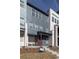 Charming townhome with a covered front porch and a combination of siding and brick, presenting a modern look at 10177 E 62Nd Ave, Denver, CO 80238