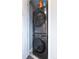 Modern stacked washer and dryer, creating a functional and space-saving laundry area at 10177 E 62Nd Ave, Denver, CO 80238