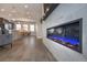 Open-concept living space with a linear fireplace and seamless flow into the kitchen and dining area at 10177 E 62Nd Ave, Denver, CO 80238