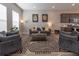 Well-lit living room featuring a comfortable seating arrangement and an open flow to the kitchen at 10177 E 62Nd Ave, Denver, CO 80238