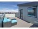 Inviting rooftop deck features stylish blue outdoor seating, perfect for relaxing and enjoying the view at 10177 E 62Nd Ave, Denver, CO 80238
