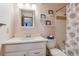 Charming pink bathroom features a vanity, toilet, and tub/shower combination, complemented by stylish floral accents at 9942 Lane St, Thornton, CO 80260