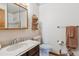 Cozy bathroom with a vanity, toilet, and shower-tub combination, enhanced by a decorative mirror and accents at 9942 Lane St, Thornton, CO 80260