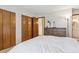 A bedroom with ample storage, featuring built-in wooden closets and a spacious dresser, providing practical elegance at 9942 Lane St, Thornton, CO 80260