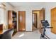 Functional room with bookshelves and exercise equipment near closet and bathroom doors, suitable for an office space at 9942 Lane St, Thornton, CO 80260
