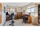 Versatile room features a desk, bookshelves, exercise equipment, and window views, suited for work or leisure at 9942 Lane St, Thornton, CO 80260