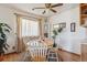 Cozy dining room with hardwood floors, a round table, and natural light at 9942 Lane St, Thornton, CO 80260