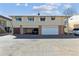 Two story home featuring garages with red awnings over the upstairs windows at 9942 Lane St, Thornton, CO 80260