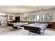 Spacious game room with pool tables, windows, and natural light at 9942 Lane St, Thornton, CO 80260