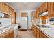 Functional kitchen with ample counter space, wooden cabinets, and essential appliances at 9942 Lane St, Thornton, CO 80260