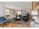 Inviting living room with hardwood floors, plush rug, and comfortable furnishings at 9942 Lane St, Thornton, CO 80260