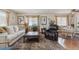 Comfortable living room with plush rug, neutral tones, and natural lighting at 9942 Lane St, Thornton, CO 80260