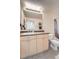 Bright and well-lit bathroom with modern vanity, a large mirror, and a combination shower-tub at 5677 S Park Pl # D310, Greenwood Village, CO 80111