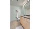 Clean bathroom with a large mirror, sleek vanity, and a tile floor at 5677 S Park Pl # D310, Greenwood Village, CO 80111
