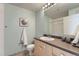 Bright bathroom with light-colored cabinets, contemporary fixtures, and shower with glass door at 5677 S Park Pl # D310, Greenwood Village, CO 80111