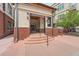 Close-up of the building entrance leading to Village Lofts, with stairs and a ramp and landscaping to the rear at 5677 S Park Pl # D310, Greenwood Village, CO 80111