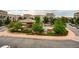 Overhead view of the community pool area with surrounding buildings, landscaping, and nearby parking at 5677 S Park Pl # D310, Greenwood Village, CO 80111
