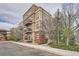 Attractive multi-story apartment building with brick accents, multiple balconies, and lush landscaping at 5677 S Park Pl # D310, Greenwood Village, CO 80111