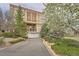 Beautiful exterior view of building with an attached garage surrounded by lush landscaping and a blue cloudy sky at 5677 S Park Pl # D310, Greenwood Village, CO 80111
