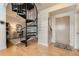 A welcoming foyer with a stylish staircase and a view into other rooms of the condo at 5677 S Park Pl # D310, Greenwood Village, CO 80111