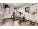 A fully-equipped gym with various machines for cardio and strength training, plus a wall-mounted TV at 5677 S Park Pl # D310, Greenwood Village, CO 80111
