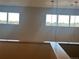 Second level hallway offers views of the spacious living area, emphasizing the home's open design at 5677 S Park Pl # D310, Greenwood Village, CO 80111