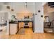 Bright kitchen with stainless steel appliances, wooden cabinets, and modern light fixtures at 5677 S Park Pl # D310, Greenwood Village, CO 80111