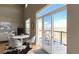 Living room view featuring a balcony walkout, hardwood floors, and lots of natural light at 5677 S Park Pl # D310, Greenwood Village, CO 80111