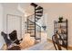 Inviting living room features a unique spiral staircase and hardwood floors, leading to additional living spaces at 5677 S Park Pl # D310, Greenwood Village, CO 80111
