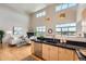 Bright and airy open-concept living area featuring modern kitchen with lots of natural light and fireplace at 5677 S Park Pl # D310, Greenwood Village, CO 80111