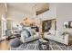 Bright, open-concept living room featuring modern decor and a spiral staircase leading to the second floor at 5677 S Park Pl # D310, Greenwood Village, CO 80111