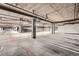 Spacious parking garage with concrete floors and ceilings; view shows a distant car and open parking space at 5677 S Park Pl # D310, Greenwood Village, CO 80111