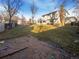 Large backyard with a lawn, patio, mature trees, and a two-story home at 1703 S Moline Ct, Aurora, CO 80012