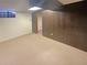Finished basement features carpet, wood paneling, and a window for natural light at 1703 S Moline Ct, Aurora, CO 80012