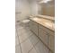 Bright bathroom with double vanity, white cabinetry, and tiled floor at 1703 S Moline Ct, Aurora, CO 80012