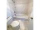 A tiled bathroom with a shower-tub combo, toilet, and tile flooring at 1703 S Moline Ct, Aurora, CO 80012