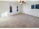 Spacious bedroom with carpet, neutral walls, ceiling fan, and natural light from three windows at 1703 S Moline Ct, Aurora, CO 80012