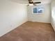 A bedroom featuring carpet, neutral walls, ceiling fan, and a single window at 1703 S Moline Ct, Aurora, CO 80012