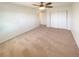 A bedroom featuring carpet, neutral walls, a ceiling fan, and a large closet at 1703 S Moline Ct, Aurora, CO 80012