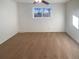 A bedroom featuring carpet, neutral walls, a ceiling fan, and a large window at 1703 S Moline Ct, Aurora, CO 80012