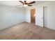 Bright bedroom features neutral carpet, a ceiling fan, and a closet through a doorway at 1703 S Moline Ct, Aurora, CO 80012
