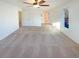 Large bedroom with carpet, ceiling fan, natural light, and door leading to bathroom at 1703 S Moline Ct, Aurora, CO 80012