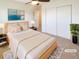 Staged primary bedroom featuring neutral decor, large closet, and soft, natural lighting at 1703 S Moline Ct, Aurora, CO 80012
